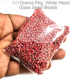 50 Grams  Pkg. White heart glass red seed beads