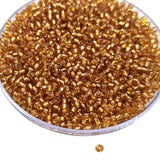 100 grams pkg. Super quality 11/0 size (2mm size) glass seed (sugar Beads) Silver line gold