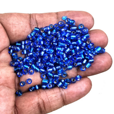 100 grams pkg. 6/0 size (4mm size) glass seed (sugar Beads) Silver line Blue Color