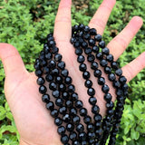 BLACK ONYX GLASS BEADS' 6 MM ROUND FACETED' 70-72 PIECES APPROX' SOLD BY PER LINE PACK