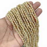 Cream Smooth Barrel Indian Handmade Glass Beads – 4x6 mm, Per Line (70-72 Beads)