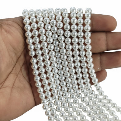 6mm Round Shell Pearl Beads with a smooth high-gloss finish, perfect for delicate bracelets, necklaces, and premium DIY jewelry designs. Uniform, durable, and elegant. Sold Per Line 67~68 beads