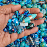250 Gram Pack, Turquoise color tone, Bead mix, lampworked glass, opaque to transparent mixed colors, 7x4mm-20x11mm mixed shapes with 1.5-2mm hole. Sold per 500 Grams pkg, approximately 180~280 beads.Depend on the size