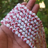 MILKY WHITE WITH LITE RED EYE' 8 MM ROUND ' SUPER FINE QUALITY EVIL EYE GLASS CRYSTAL BEADS SOLD BY PER LIN PACK' APPROX PIECES 47-48 BEADS